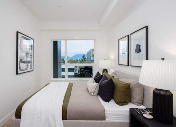 a bedroom with a large bed and a large window