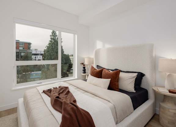 a bedroom with a large bed and a large window