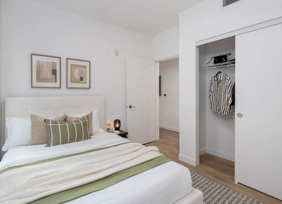 a bedroom with a bed and a closet