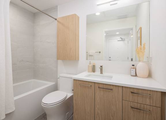 a bathroom with a sink toilet and a mirror