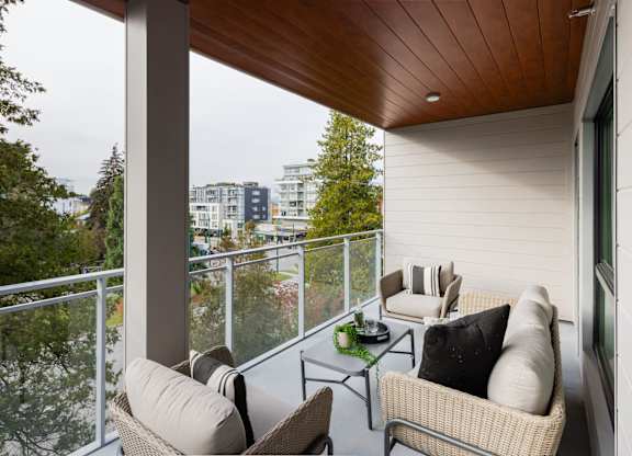 a balcony with furniture and a view of the city