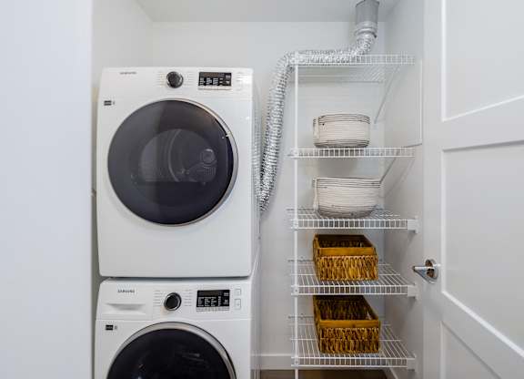 A white washing machine and dryer in a laundry room.
