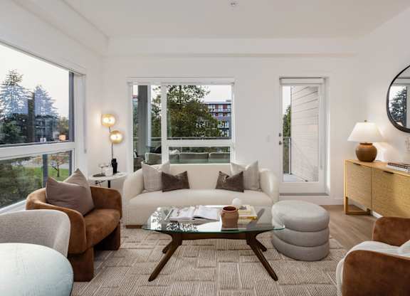 a living room with a white couch and a coffee table