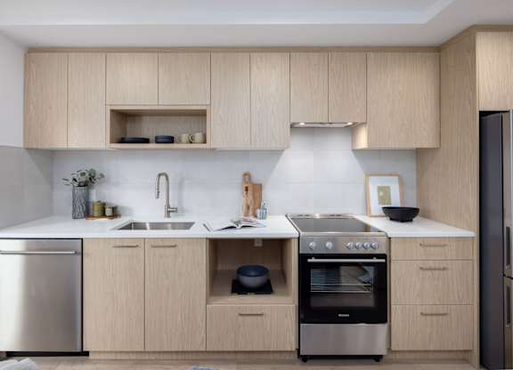 a kitchen with wooden cabinets and stainless steel appliances
