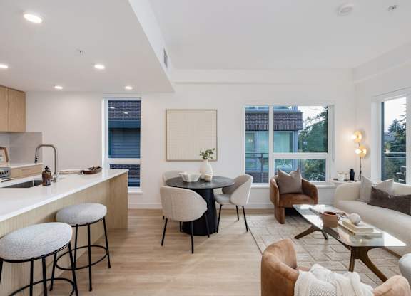 a living room with a kitchen and a dining room