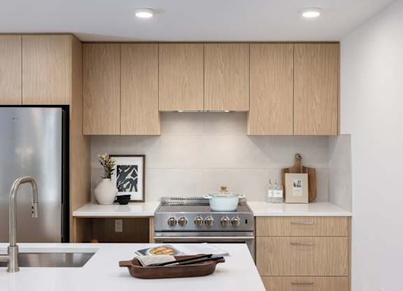 a kitchen with wooden cabinets and a stove and a sink