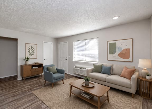 A living room with a couch, chair, and coffee table.