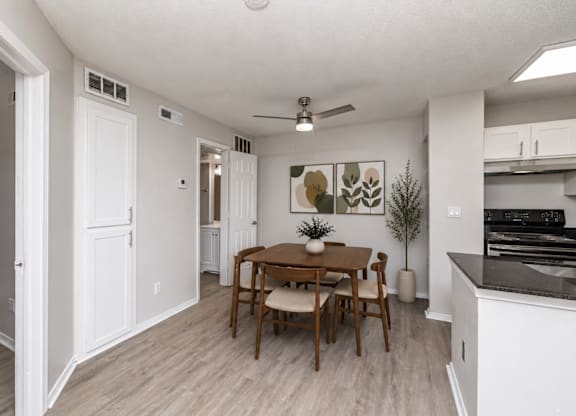 A dining room with a table and chairs.