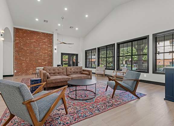 A living room with a brick wall and a couch.