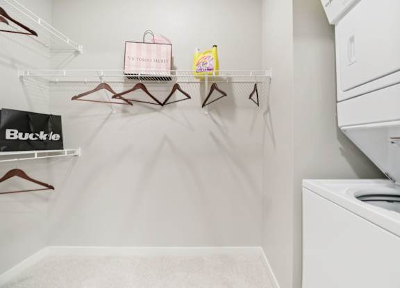 A white laundry room with a washer and dryer.