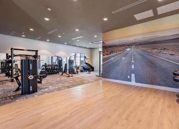 A gym with a wall mural of a road.