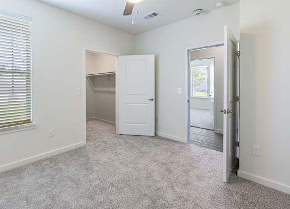 A room with a white door and a white cabinet.