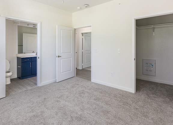 A room with a carpeted floor and white walls.