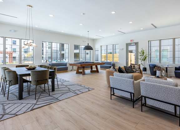 A spacious living room with a dining table and chairs.