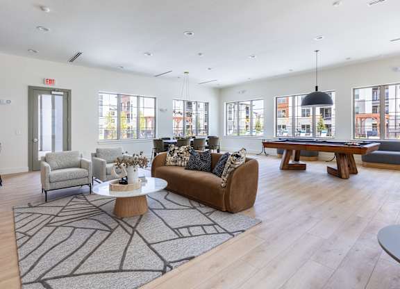 A living room with a brown couch and a coffee table.