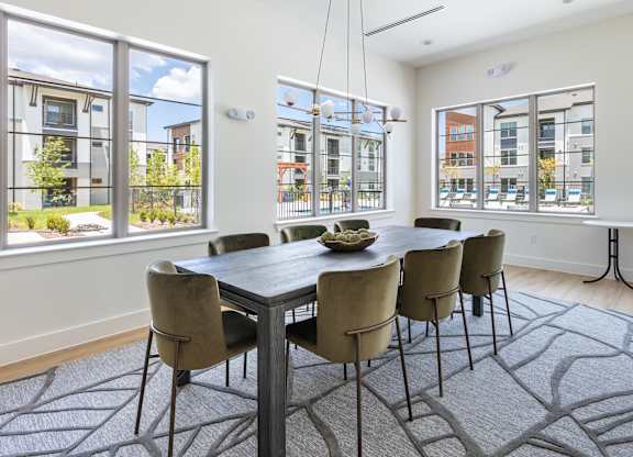 A dining room with a table and chairs.