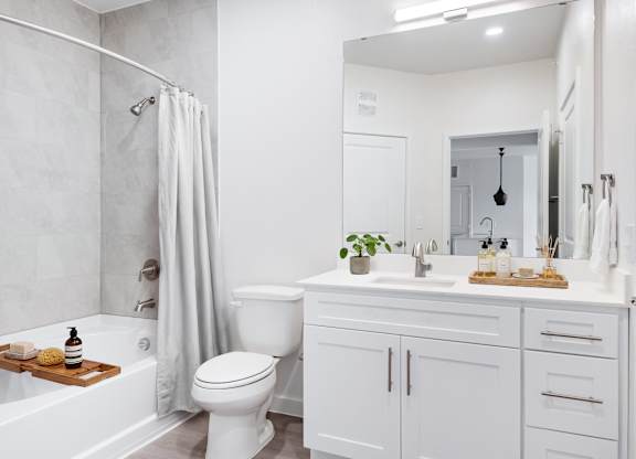 A white bathroom with a toilet, sink, and bathtub at 901 Rendon, Burleson, TX
