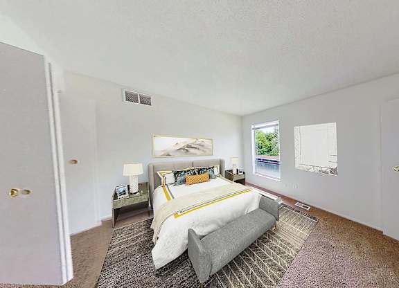 A bedroom with a large bed and a painting on the wall.