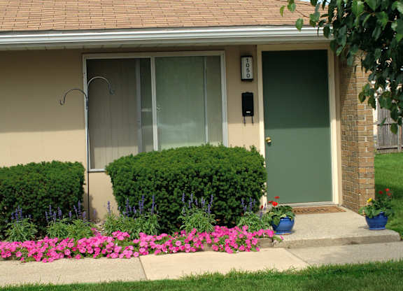 A house with a green door and a grey front door.