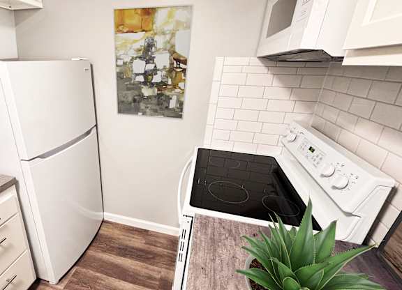 A kitchen with a white refrigerator, a white oven, and a white microwave.