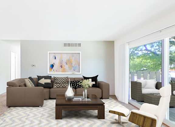 A living room with a brown couch, a coffee table, and a painting on the wall.