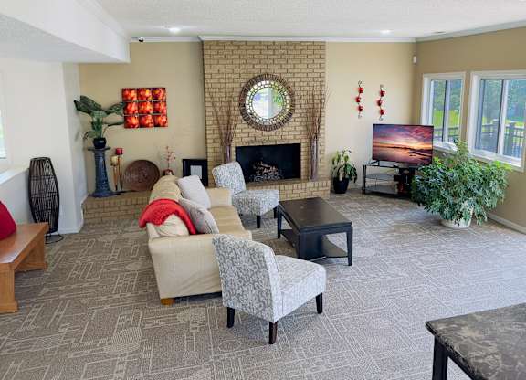 A living room with a fireplace and a flat screen TV.