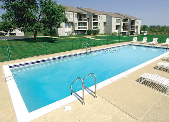 A swimming pool with a metal ladder in the middle of it.