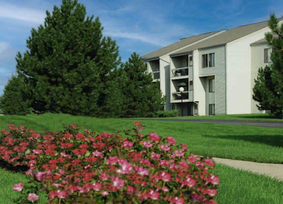 A building with a green lawn in front of it.