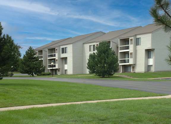 Apartment complex with green grass in front.