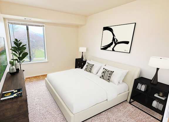A bedroom with a large bed, a window, and a TV.