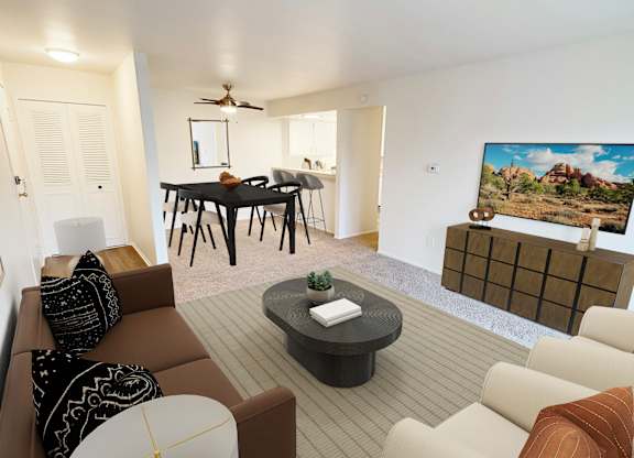 A living room with a brown couch and a painting of a house on the wall.