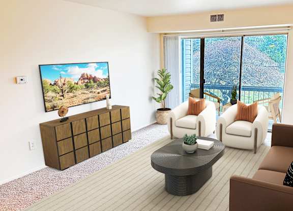 A living room with a flat screen TV and a large window.
