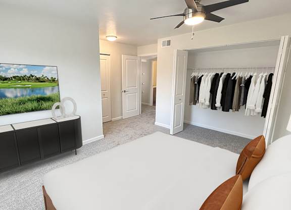 A bedroom with a large bed, a television, and a wardrobe.