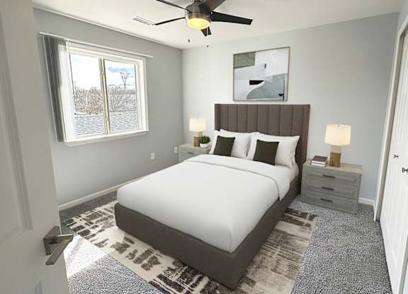 A bedroom with a bed, nightstands, and a ceiling fan.