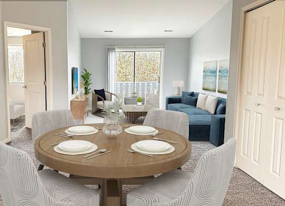 A dining room with a round table set for four.