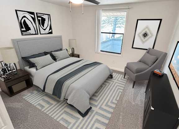 A bedroom with a bed, chair, and a window.