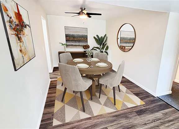 A dining room with a table and chairs.