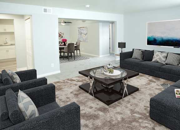 a living room with couches and chairs and a table