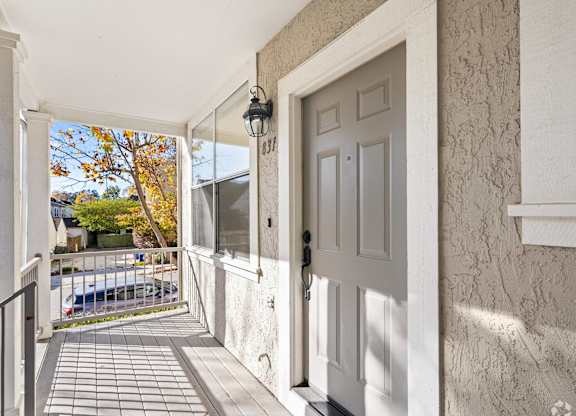 A white door is on the right side of a hallway at Westmont Place Townhomes Apartments, Santa Cruz