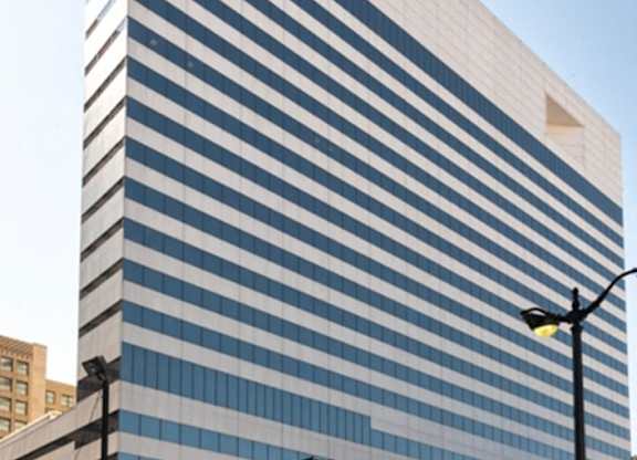 A tall building with a blue and white striped facade at 7 West 7th Apartments, Cincinnati Ohio