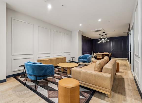 A living room with a blue chair and a tan couch at 7 West 7th Apartments, Cincinnati, OH