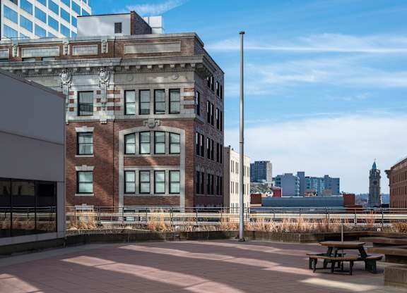 A large building with a clock tower in the background at 7 West 7th Apartments, Cincinnati