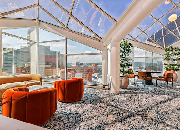 A room with orange chairs and a glass ceiling at 7 West 7th Apartments, Ohio, 45202