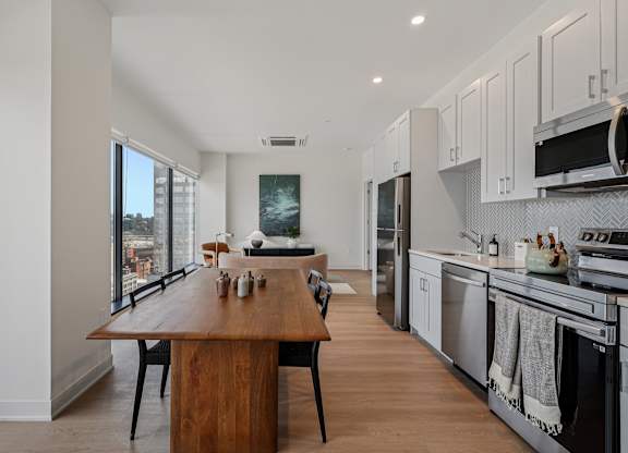 A modern kitchen with a wooden island and stainless steel appliances at 7 West 7th Apartments, Cincinnati, 45202