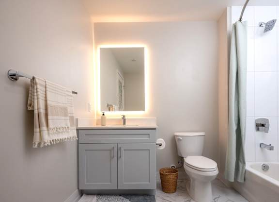 A bathroom with a toilet, sink, and bathtub.