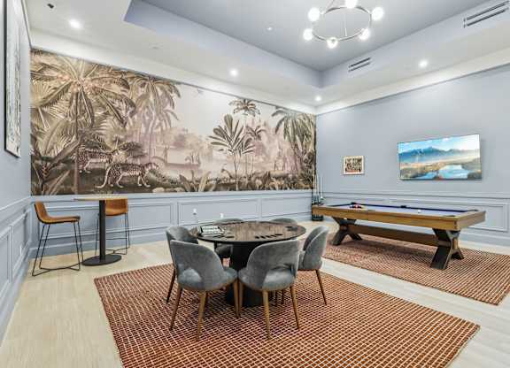 A room with a pool table and a jungle mural on the wall. at LiveWell Apartments, Pennsylvania, 15222