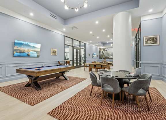 A Clubhouse room with a pool table and a dining table at LiveWell Apartments, Pittsburgh, PA