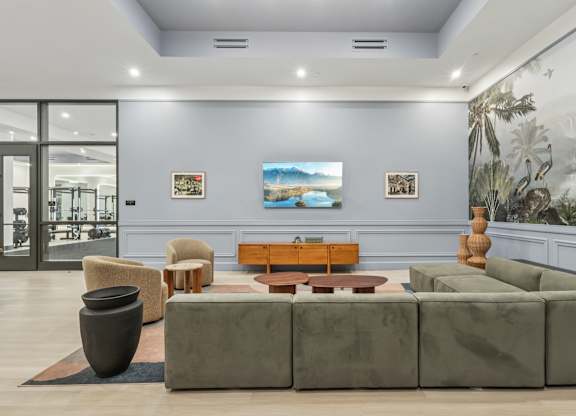 A living room with a grey couch, a brown coffee table, and a large vase. at LiveWell Apartments, Pittsburgh, PA, 15222