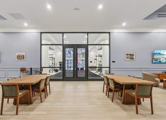 A room with a long table and chairs in front of a glass door at LiveWell Apartments, Pennsylvania, 15222