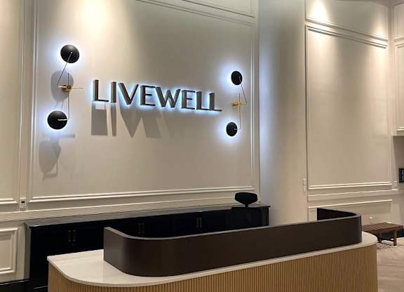 A reception area with a Livewell sign on the wall.